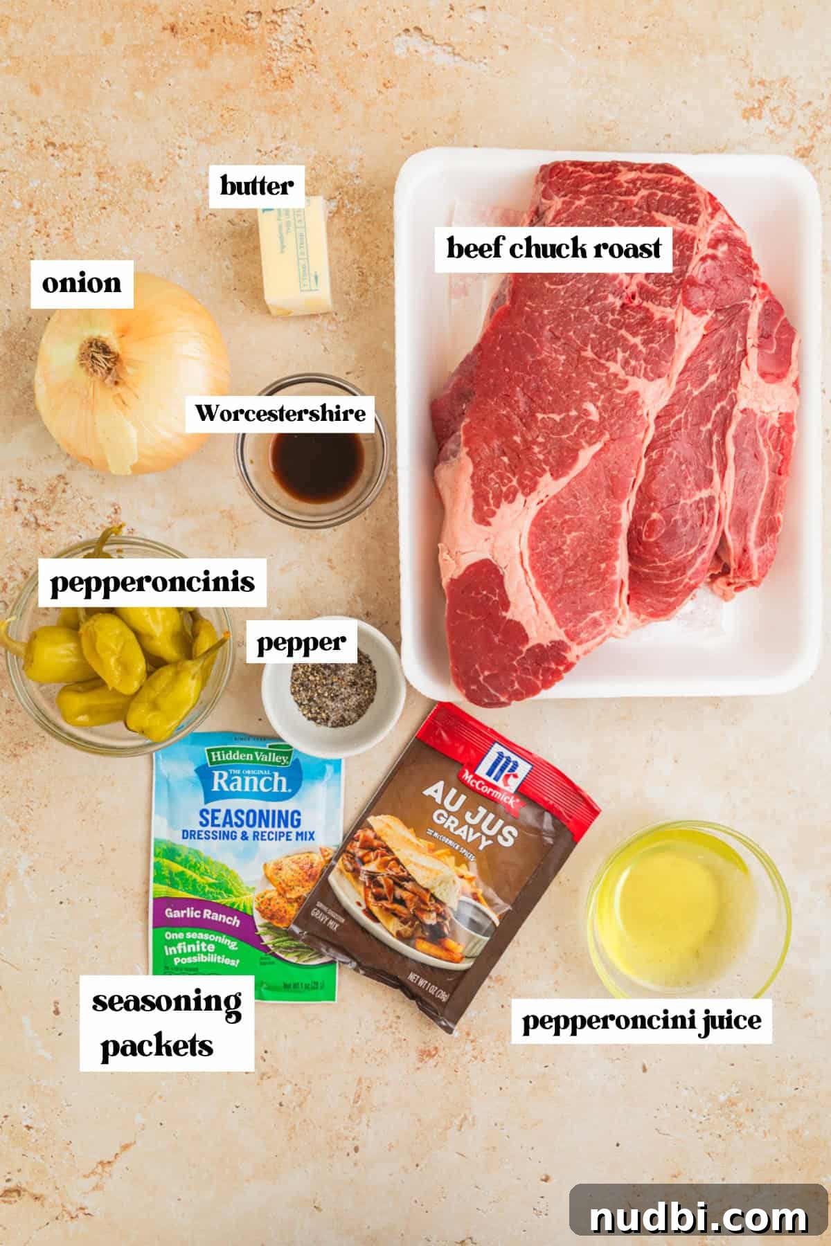 Mississippi Pot Roast in a Slow Cooker: Tender, Flavorful Recipe 3 Chuck roast, onion, peppers, and other ingredients to make recipe arranged on surface.