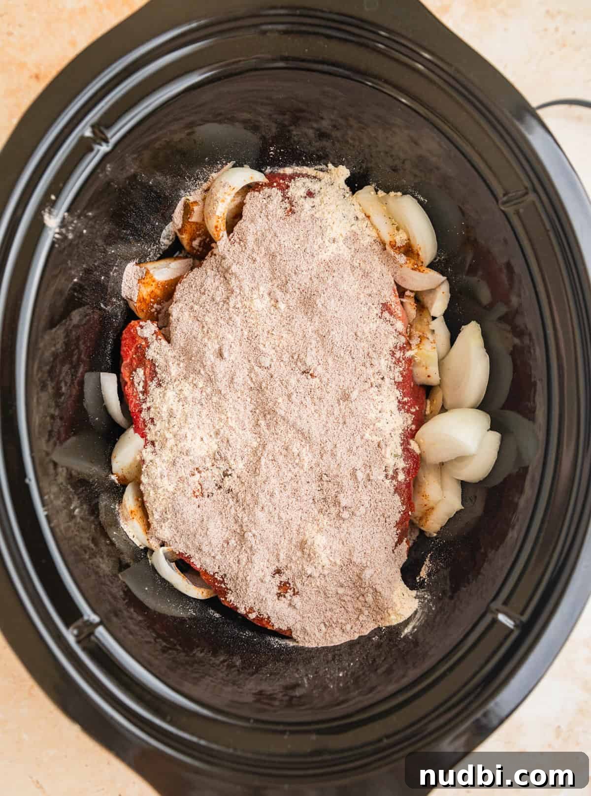 Mississippi Pot Roast in a Slow Cooker: Tender, Flavorful Recipe 4 Chuck roast in crock pot with sliced onions, ranch seasoning and au jus seasoning.