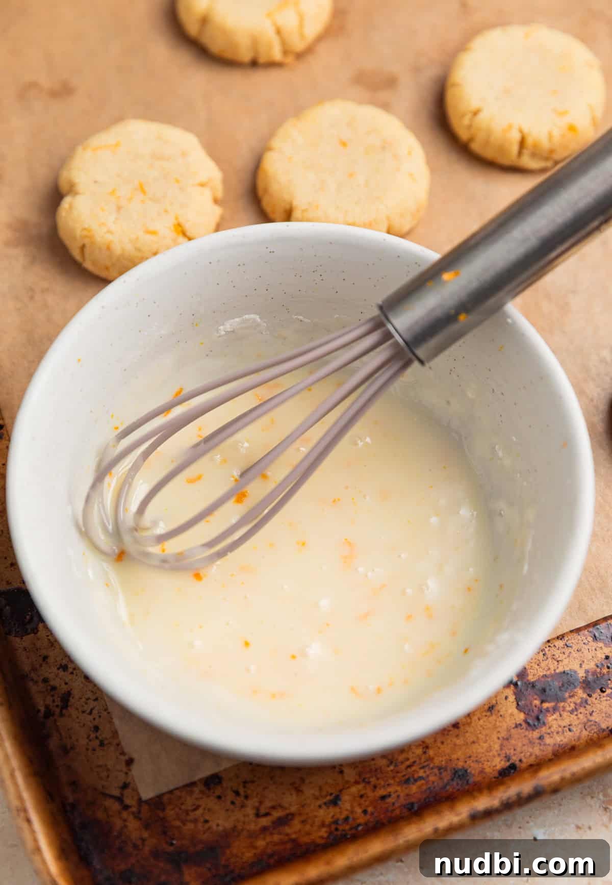 Almond Flour Orange Cookies Recipe — Light Citrus Cookie Guide 9 Orange icing in bowl with whisk.