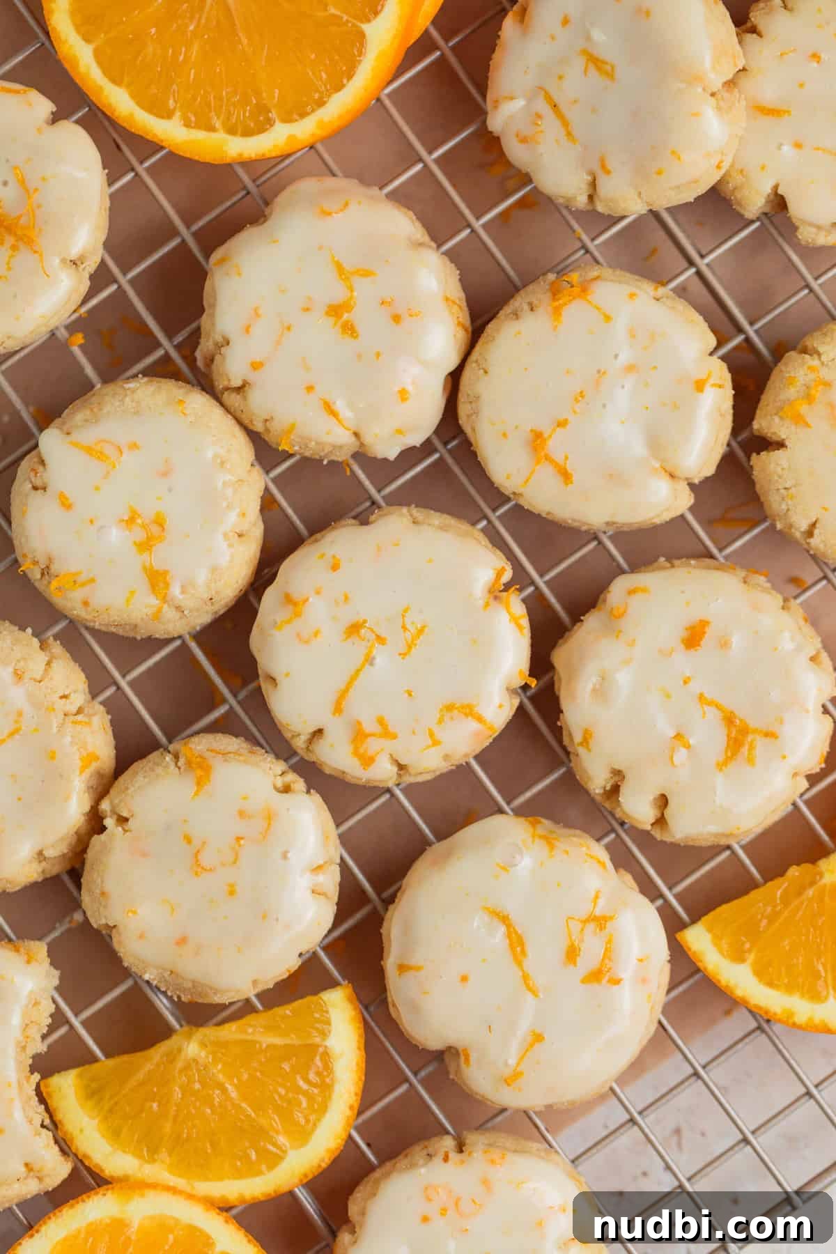 Almond Flour Orange Cookies Recipe — Light Citrus Cookie Guide 10 Overhead view of iced orange cookies on cooling rack.