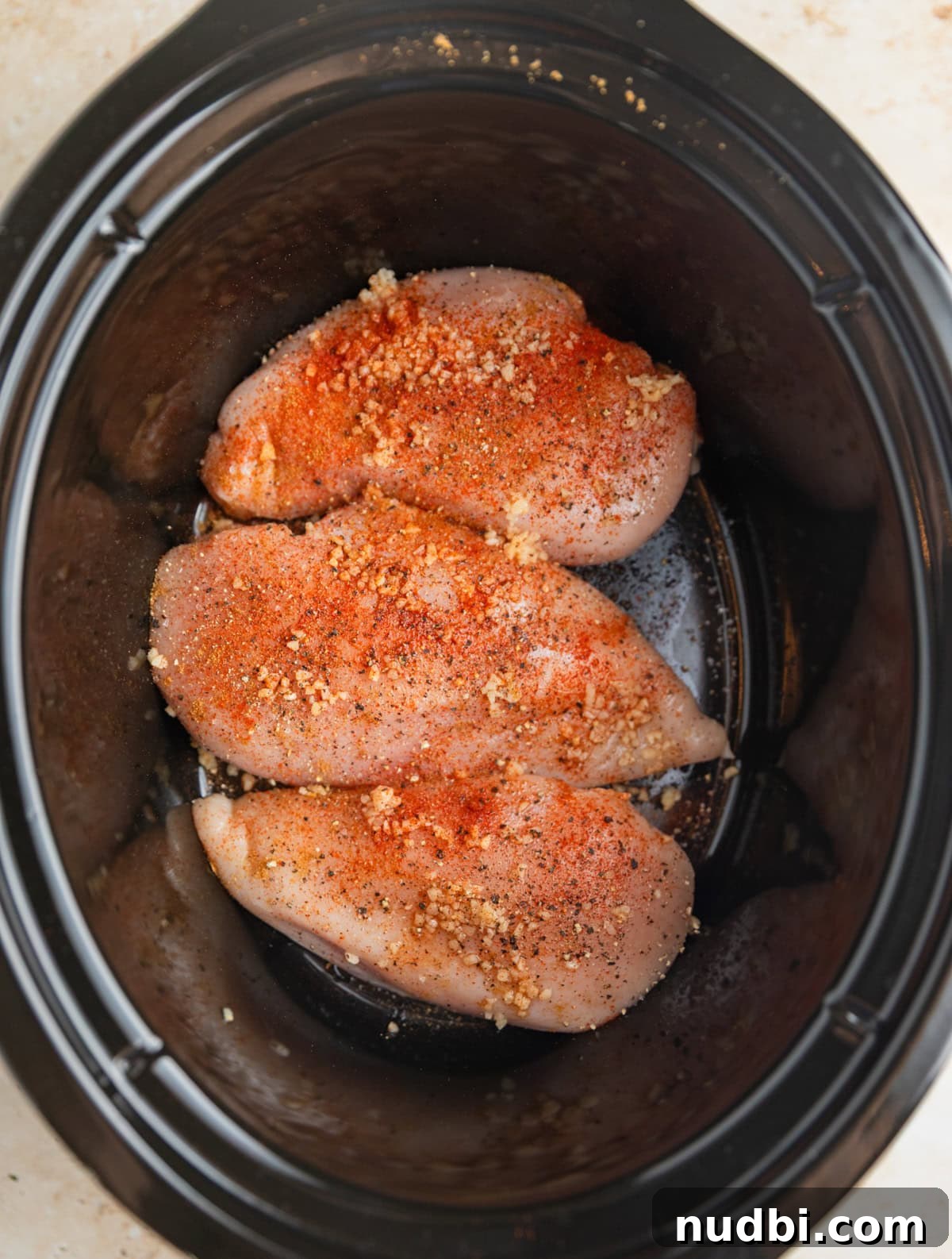 Slow Cooker BBQ Chicken Tacos with Crunchy Lime Slaw 3 Seasoned chicken breast in crockpot.