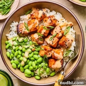 Crispy Air Fryer Salmon Bites with Lemon Garlic Dip 15 Air fryer salmon bites served with bang bang sauce over top and served on rice.