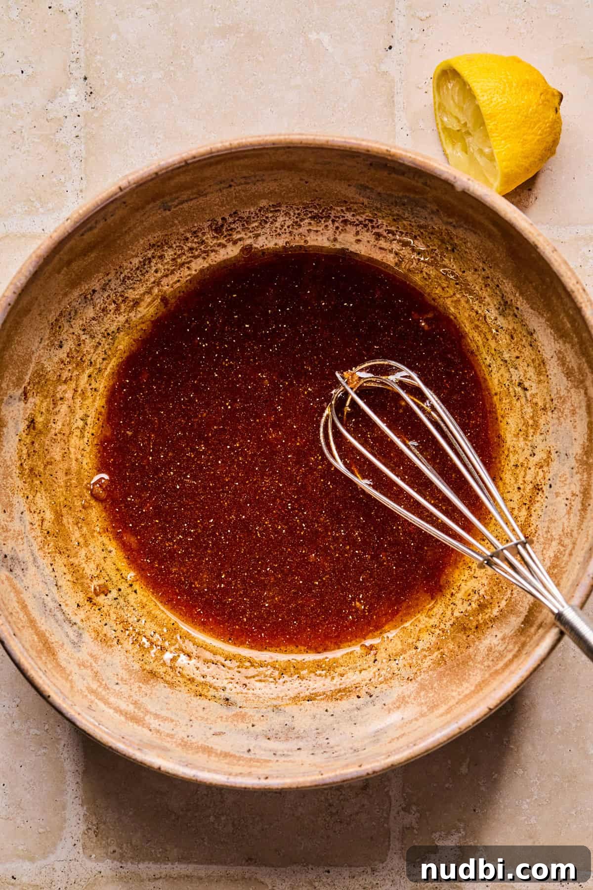 Crispy Air Fryer Salmon Bites with Lemon Garlic Dip 4 Salmon marinade in bowl with whisk.