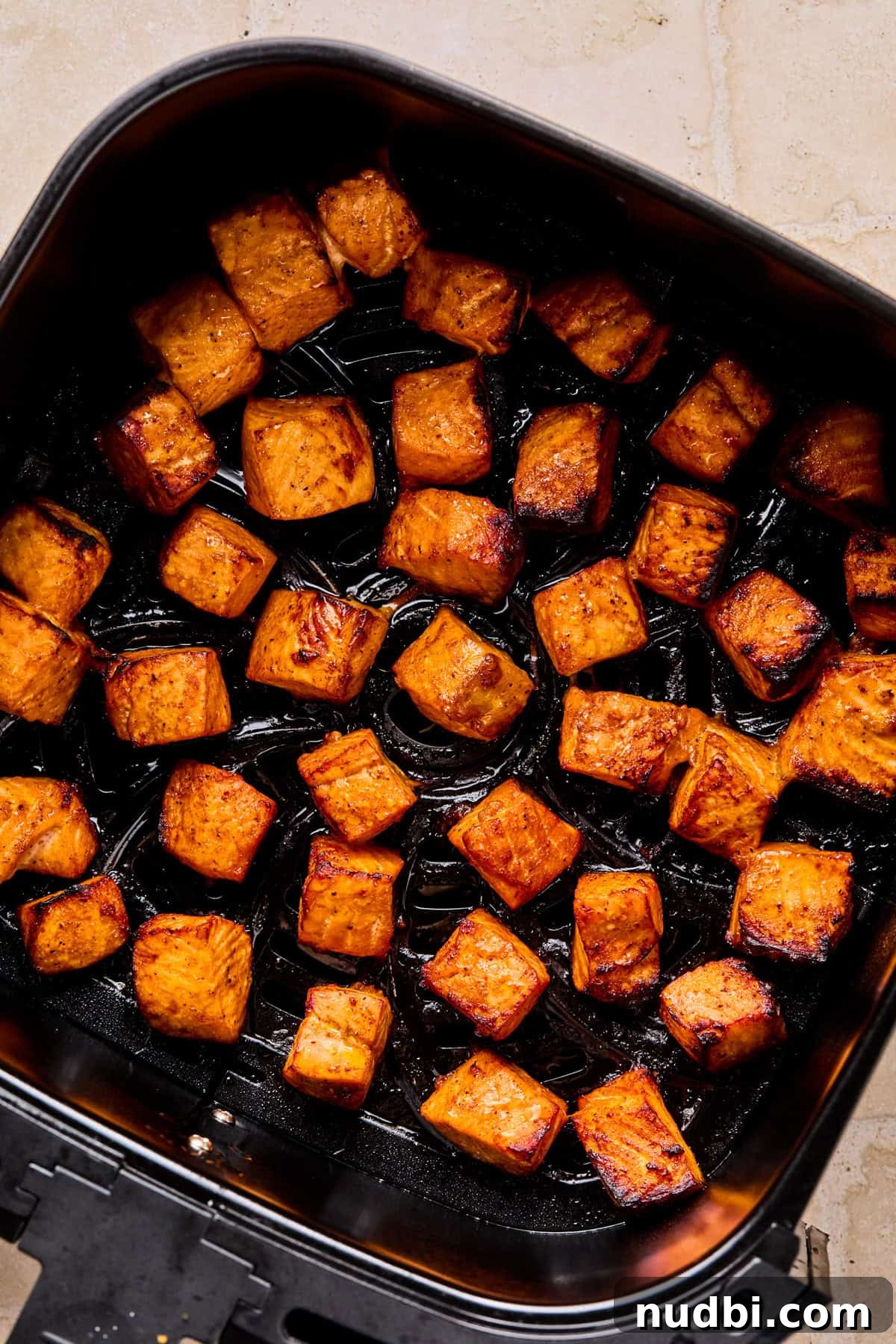 Crispy Air Fryer Salmon Bites with Lemon Garlic Dip 7 Air fried salmon bites in air frying basket.