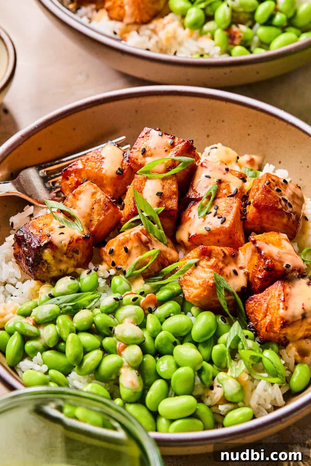 Crispy Air Fryer Salmon Bites with Lemon Garlic Dip 10 Dish with air fried salmon bites topped with bang bang sauce.