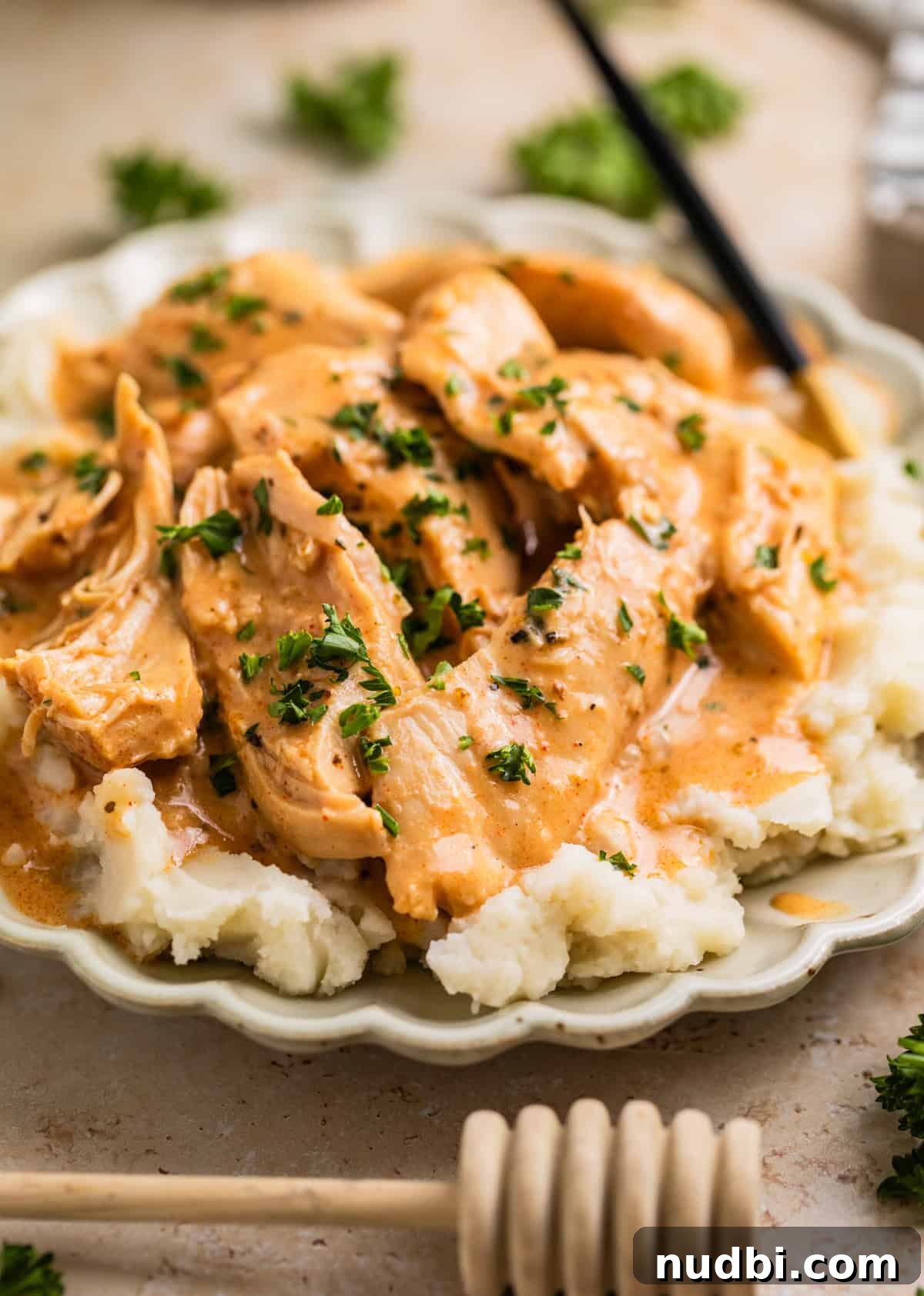 Slow Cooker Honey Mustard Chicken Recipe for Tender, Saucy Results 2 Creamy honey mustard chicken on top of mashed potatoes with chopped parsley.