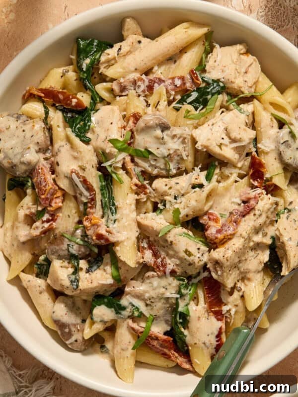 Slow Cooker Honey Mustard Chicken Recipe for Tender, Saucy Results 14 Bowl of pasta with cream sauce, chicken, mushrooms, spinach and fork propped in bowl.