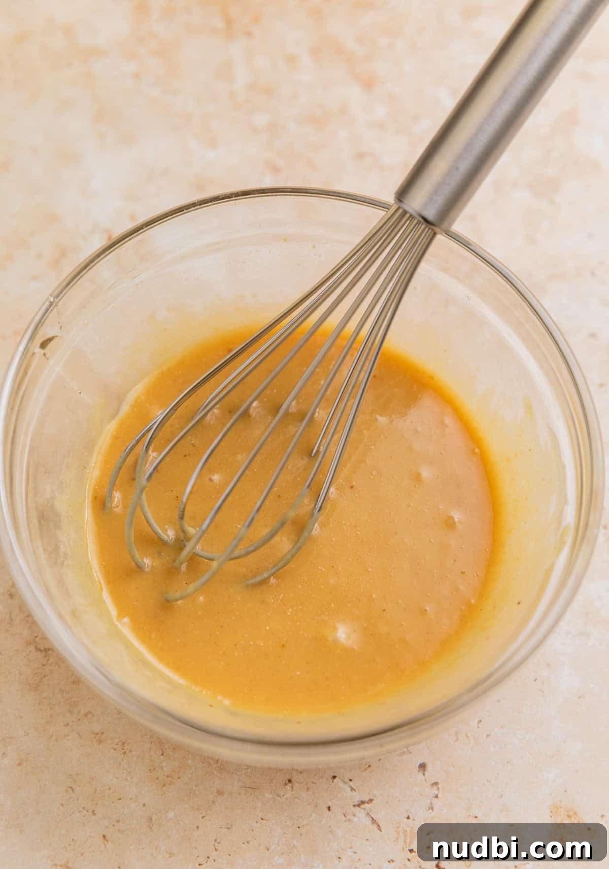 Slow Cooker Honey Mustard Chicken Recipe for Tender, Saucy Results 5 Honey mustard sauce in glass bowl with whisk.
