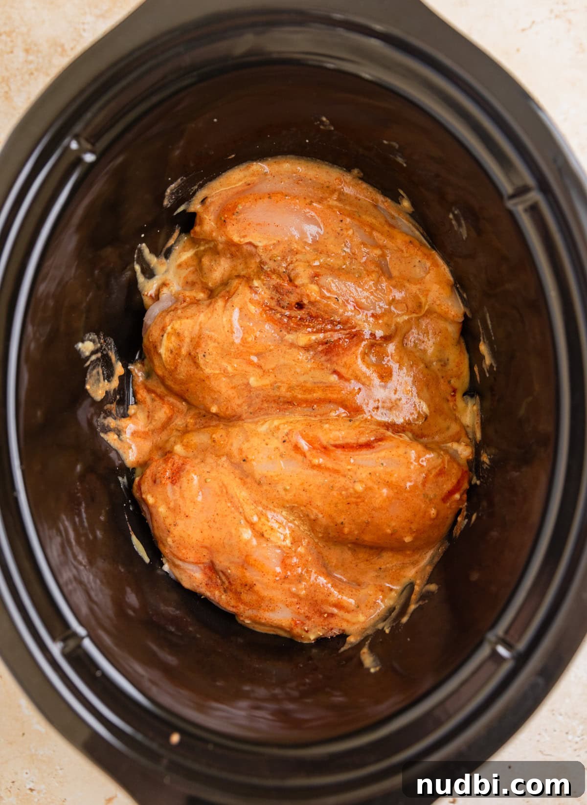 Slow Cooker Honey Mustard Chicken Recipe for Tender, Saucy Results 6 Raw chicken breasts in slow cooker topped with honey mustard sauce.