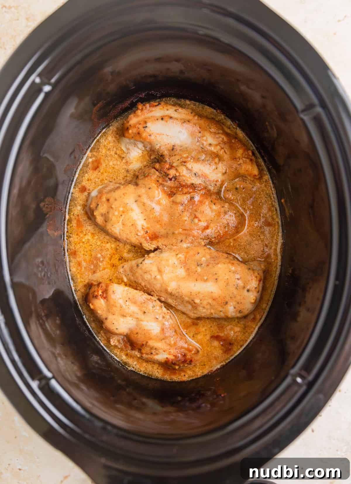 Slow Cooker Honey Mustard Chicken Recipe for Tender, Saucy Results 7 Cooked honey mustard chicken in pot.
