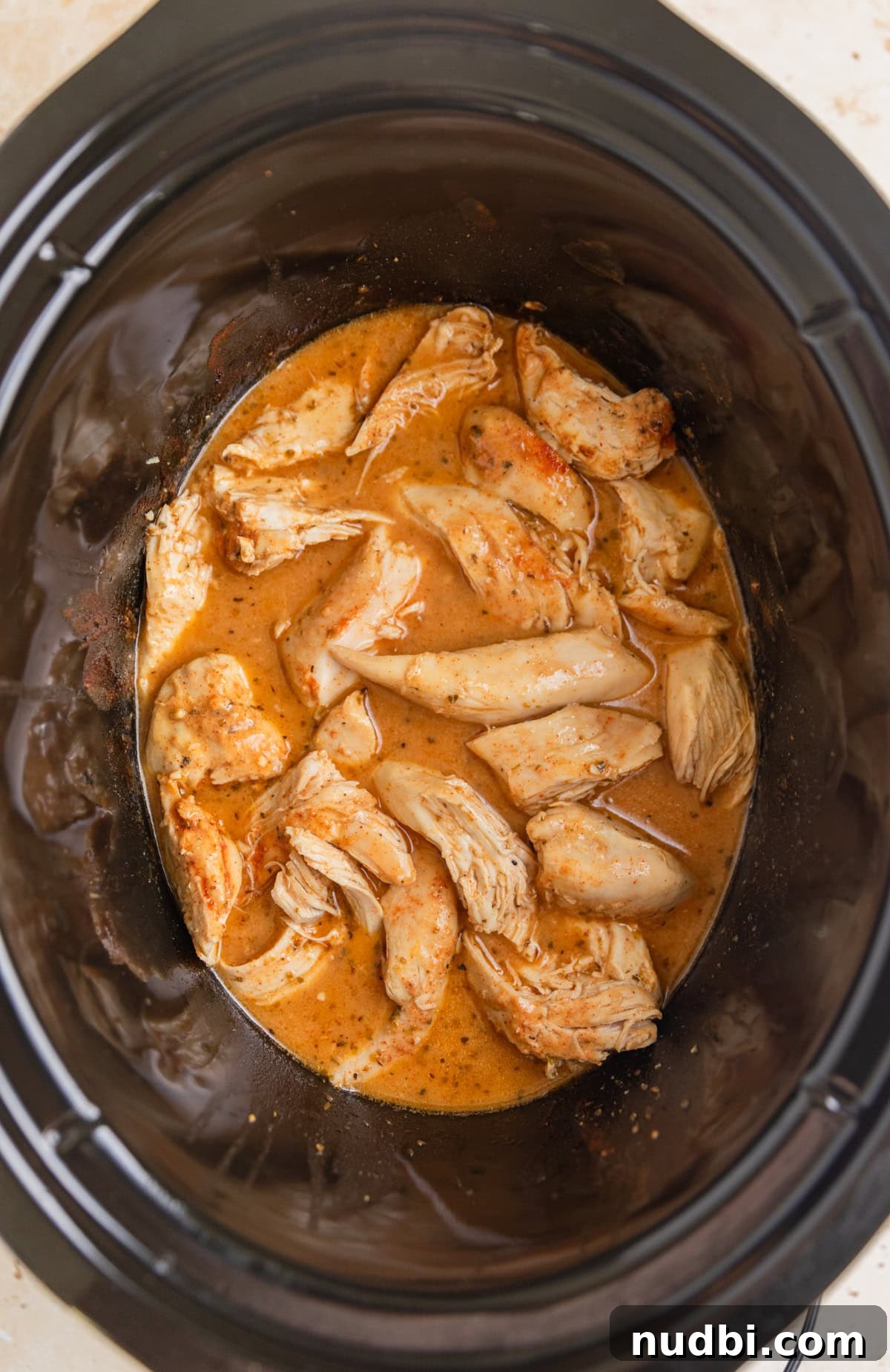 Slow Cooker Honey Mustard Chicken Recipe for Tender, Saucy Results 8 Crock pot honey mustard chicken pulled apart into pieces.