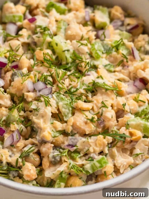 Cucumber and Sweet Corn Salad with Herb Vinaigrette 11 Bowl with mashed chickpea mock tuna salad topped with chopped red onion and dill.