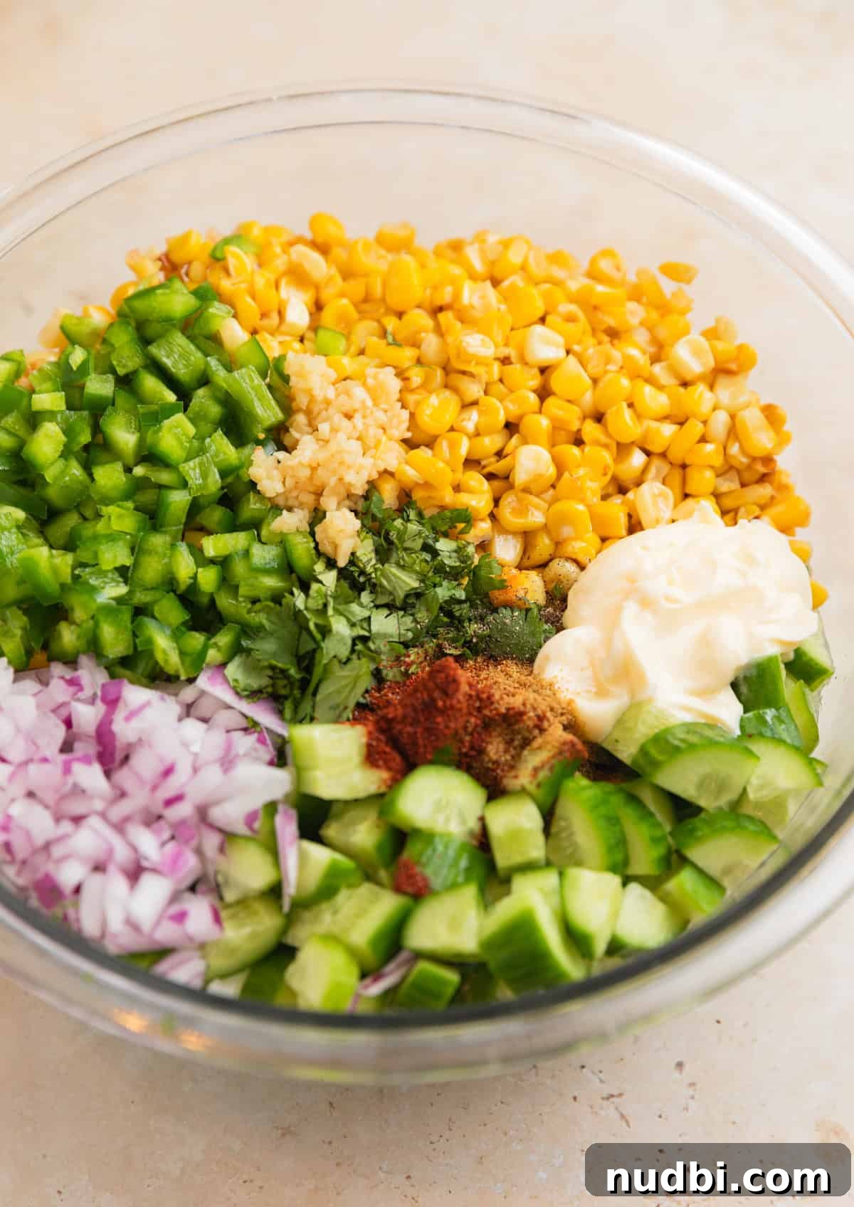Cucumber and Sweet Corn Salad with Herb Vinaigrette 5 Corn, chopped cucumber, onion, mayo, and other ingredients in bowl.