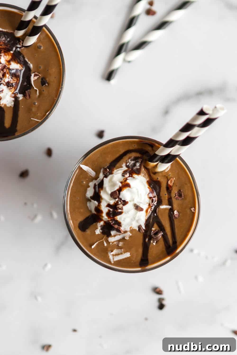 Chocolate Coconut Smoothie Recipe for Creamy, Decadent Flavor 3 Overhead shot of almond chocolate coconut smoothie with chocolate sauce and whipped cream.