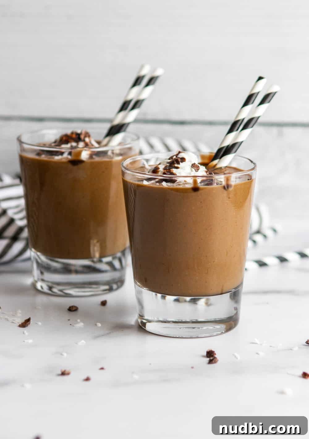 Chocolate Coconut Smoothie Recipe for Creamy, Decadent Flavor 4 almond joy smoothies with whipped cream and chocolate sauce.