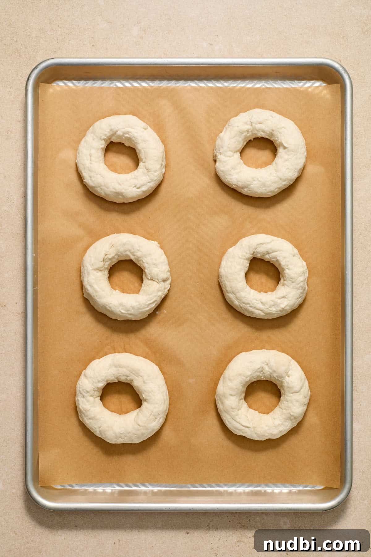 High-Protein Greek Yogurt Bagel Recipe 9 Bagels formed and arranged on parchment paper lined cookie sheet.