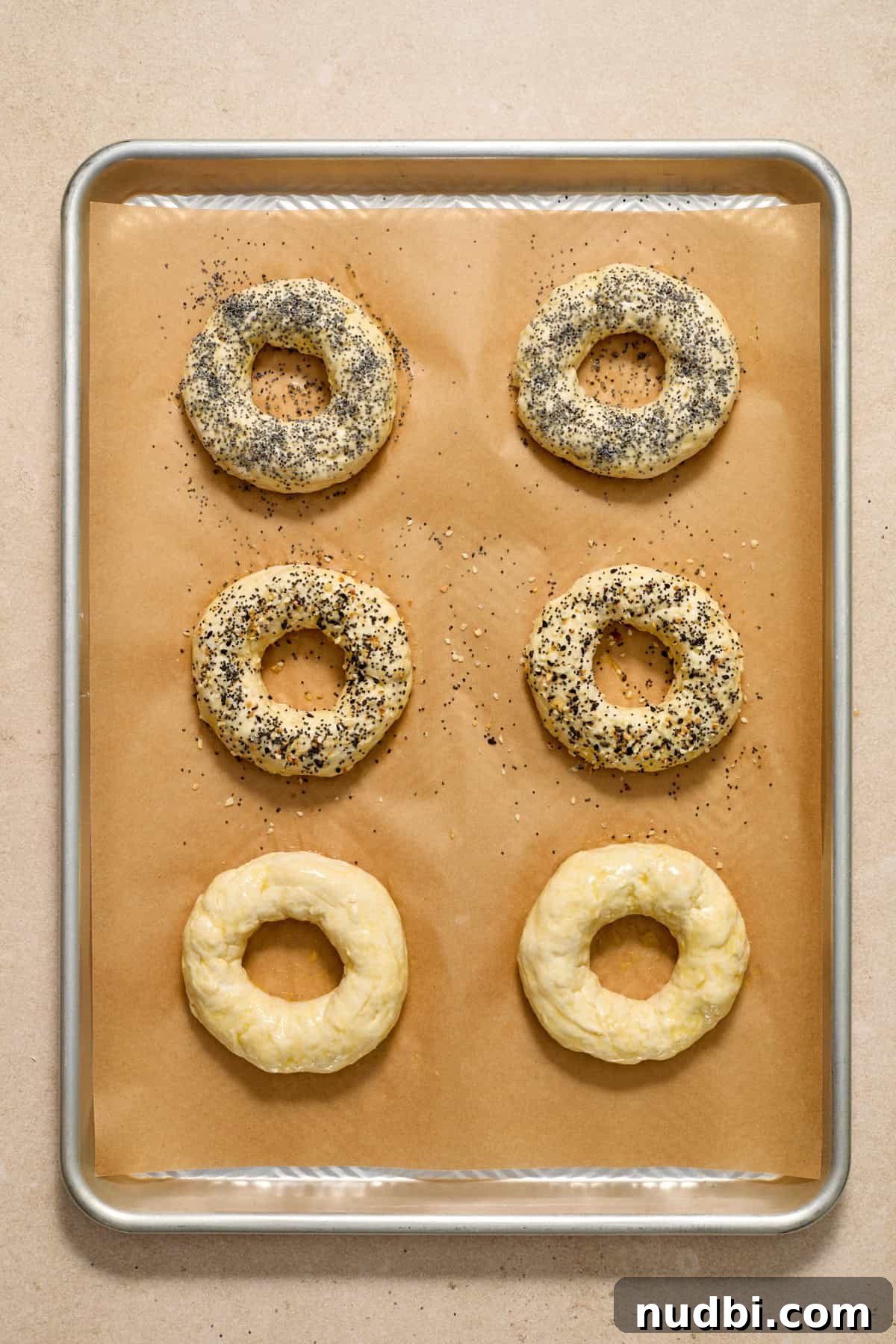 High-Protein Greek Yogurt Bagel Recipe 10 Egg washed bagels with poppy seeds and other ingredients on top.