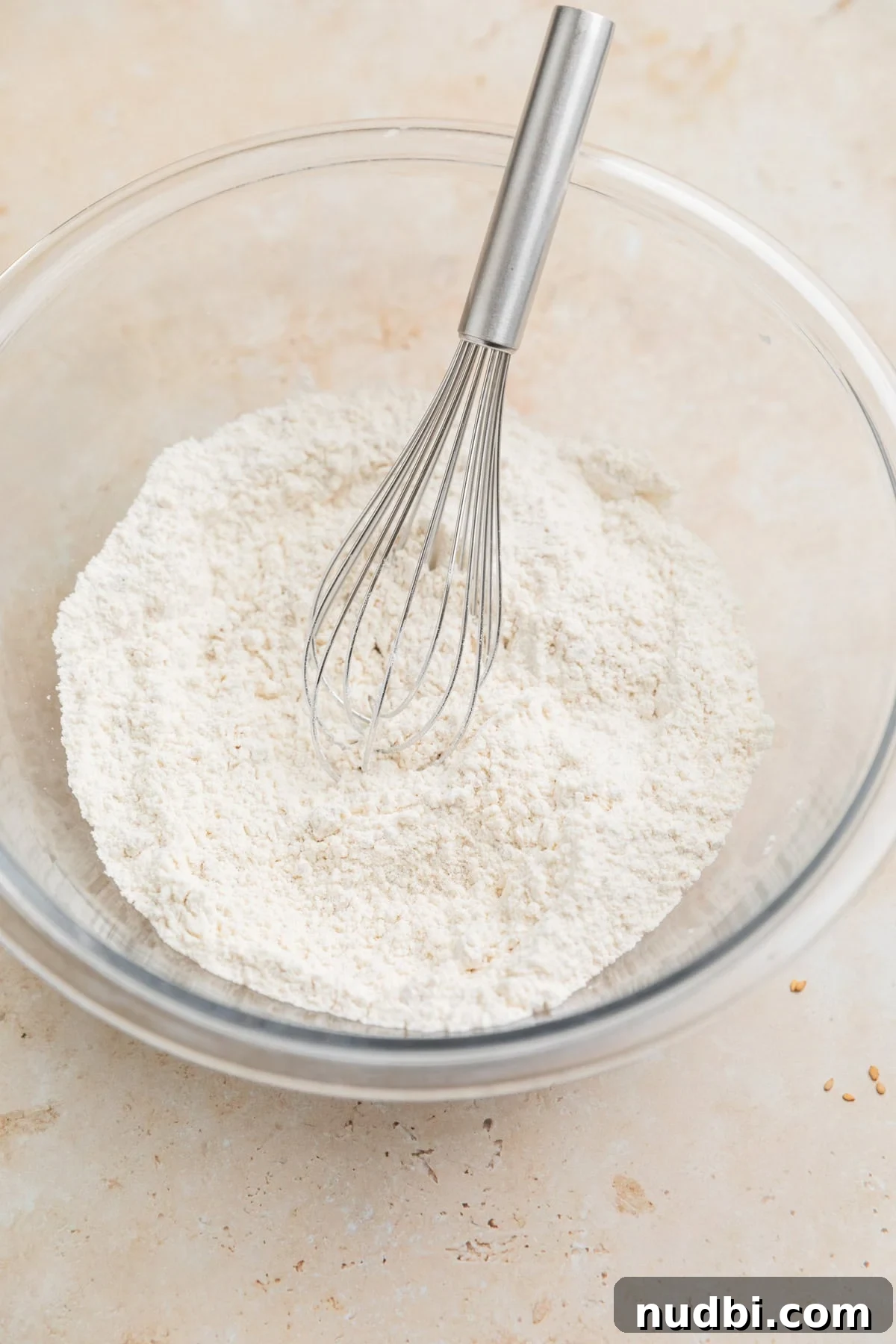 Dry ingredients in bowl with whisk.