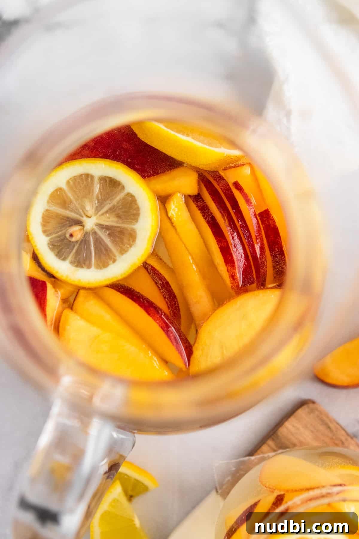 Ginger Peach White Sangria Recipe for Summer Entertaining 5 Overhead view of pitcher of peach white sangria.