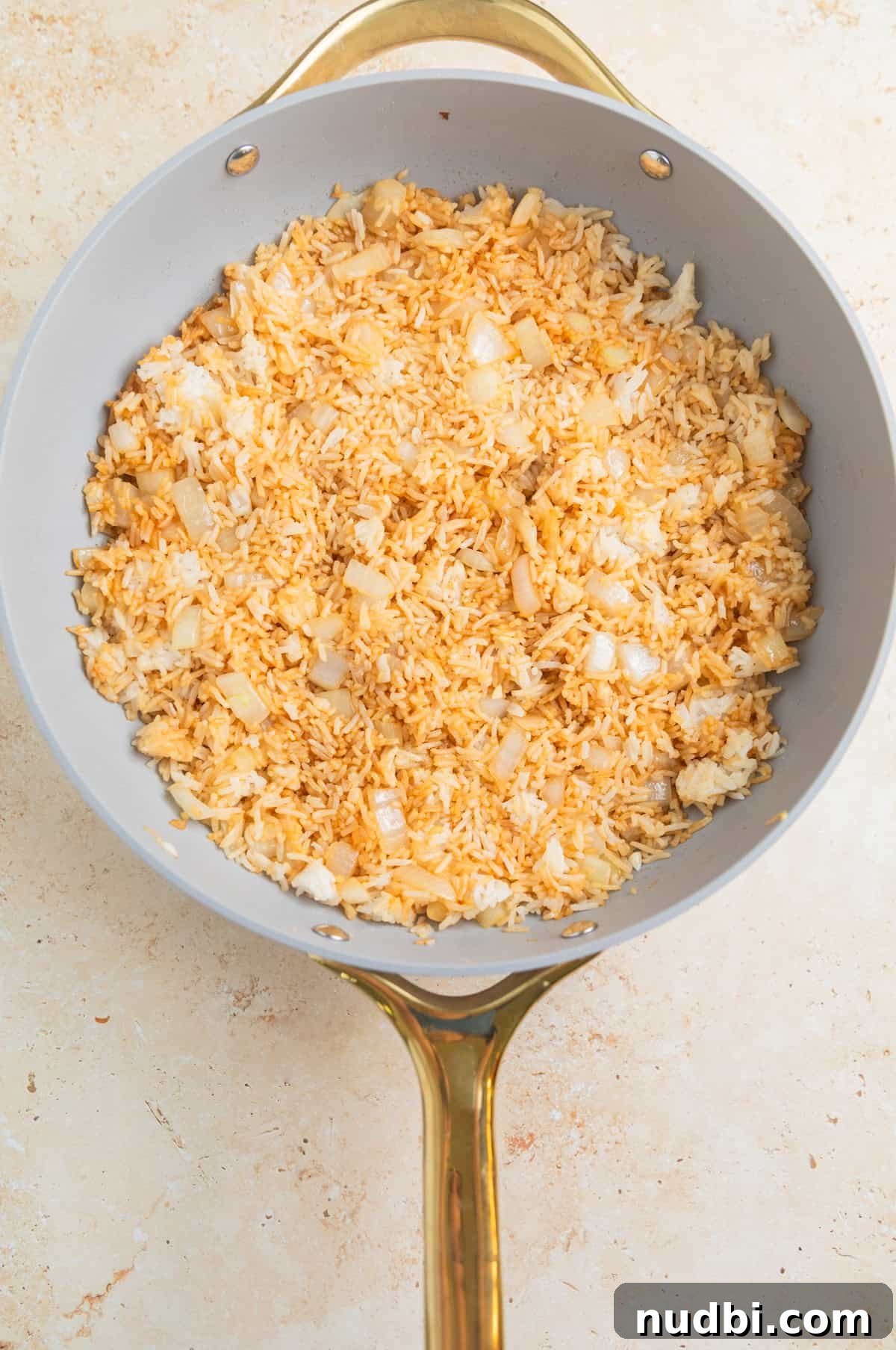 Quick Chicken Fried Rice Recipe for Perfect Weeknight Meals 6 Soy sauce and sesame oil in skillet with rice.