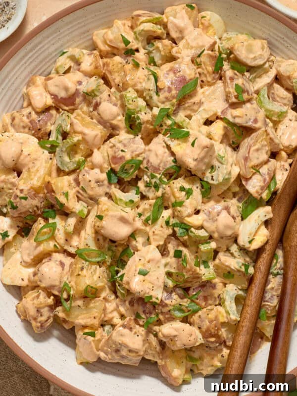 Zesty Chili Lime Chicken Recipe for Tender Grilled Chicken 11 Serving bowl with potato salad and serving utensils.