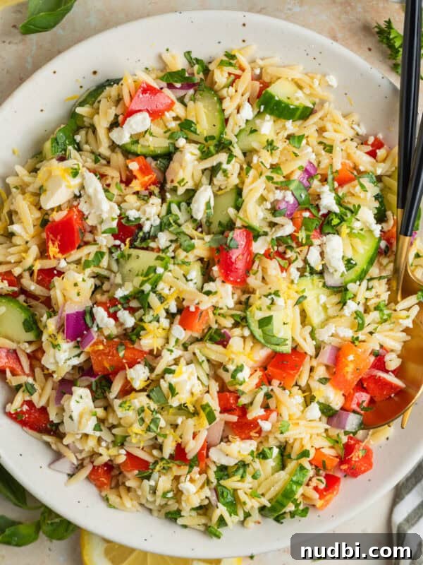 Zesty Chili Lime Chicken Recipe for Tender Grilled Chicken 9 Lemon orzo salad with cucumber, bell pepper and feta in serving dish with serving utensils.