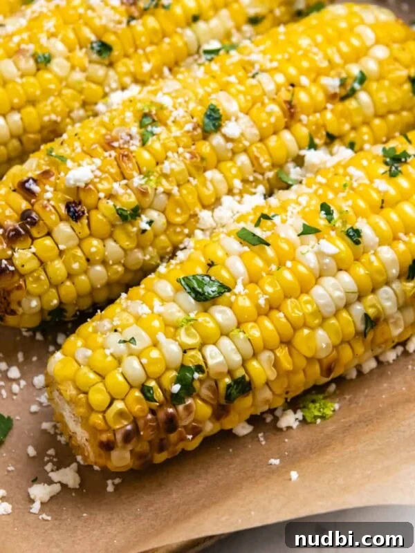 Zesty Chili Lime Chicken Recipe for Tender Grilled Chicken 10 Cilantro lime air fryer corn on the cob sitting on brown parchment.