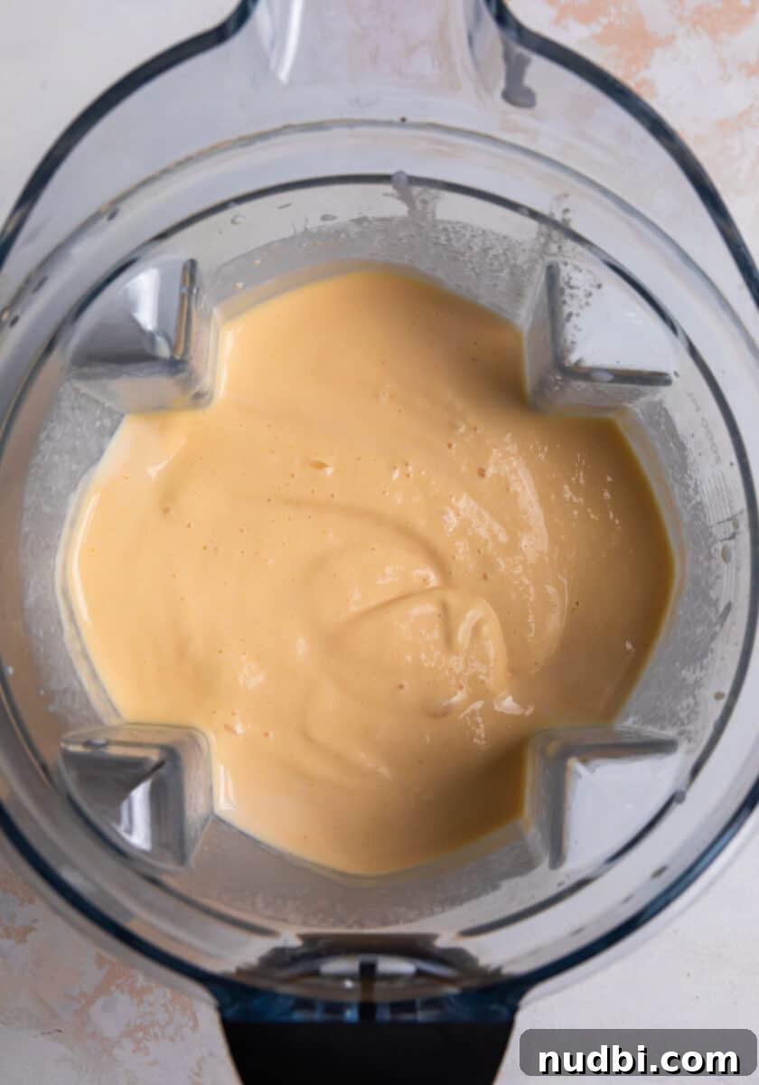 Peach popsicle mixture blended in blender.