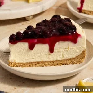No-Bake Lemon Blueberry Cheesecake Recipe — Light & Creamy Dessert 14 Lemon blueberry cheesecake slice on plate.