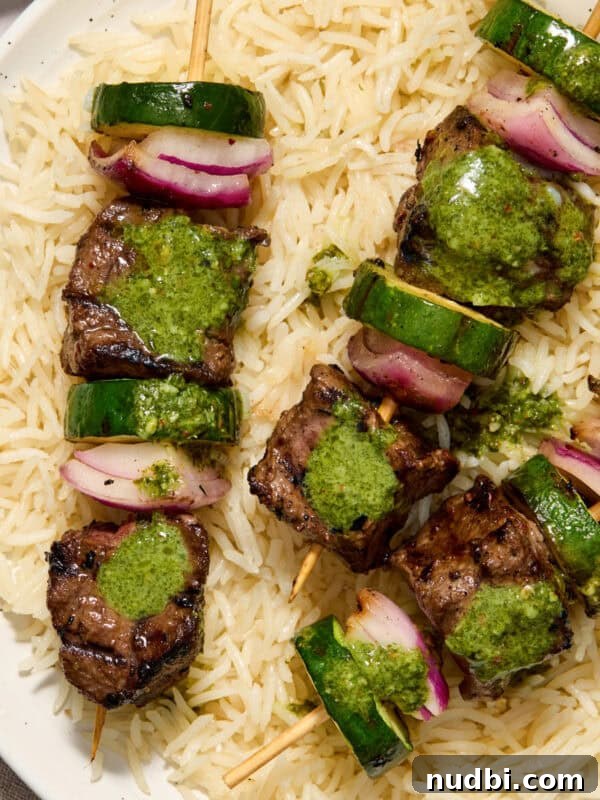 Grilled Ribeye with Creamy Gorgonzola Sauce Recipe 11 Steak kabobs arranged on a plate over rice and topped with cilantro chimichurri.