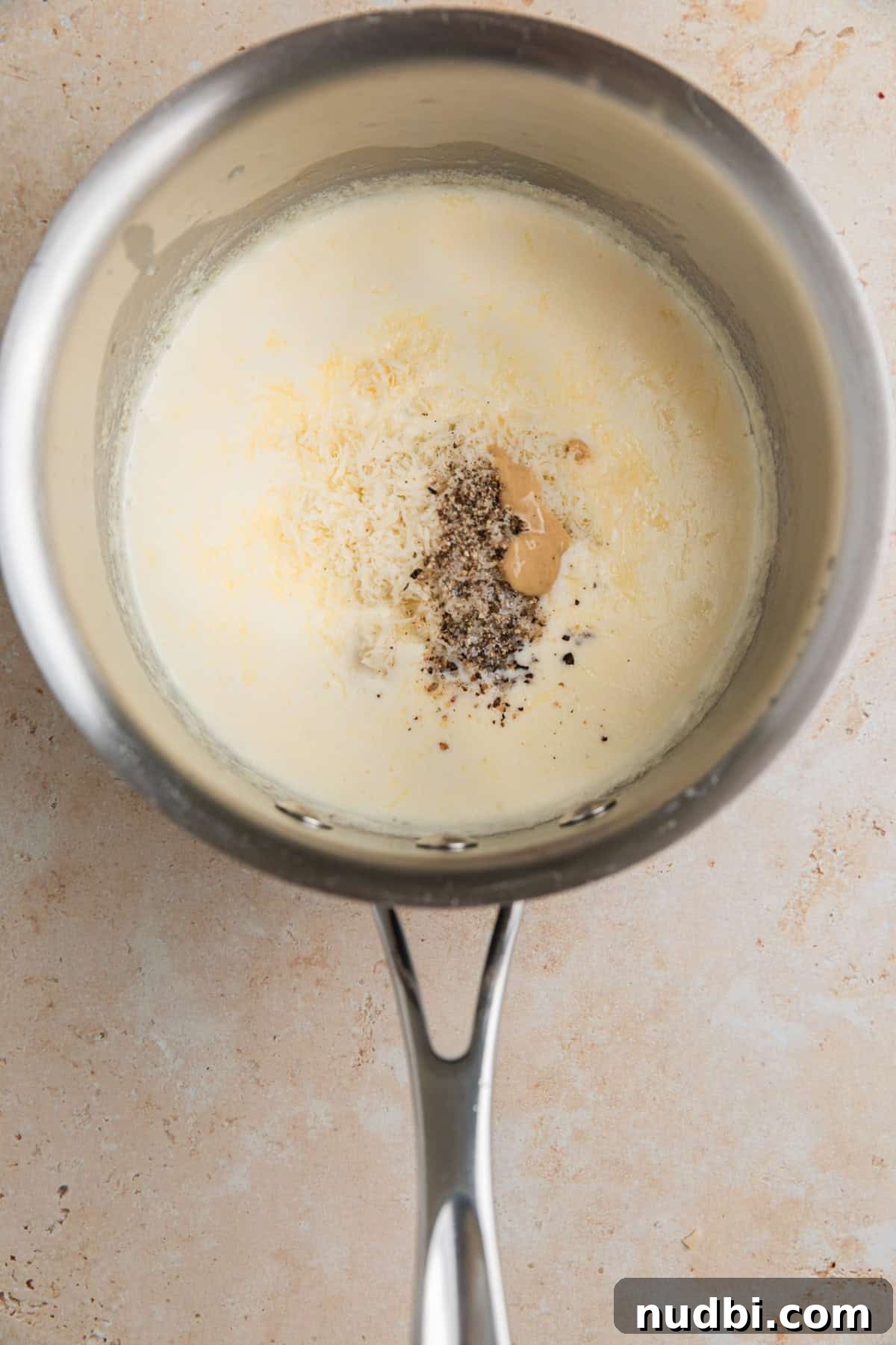 Grilled Ribeye with Creamy Gorgonzola Sauce Recipe 6 Parmesan, gorgonzola and other ingredients added to sauce pan with cream.