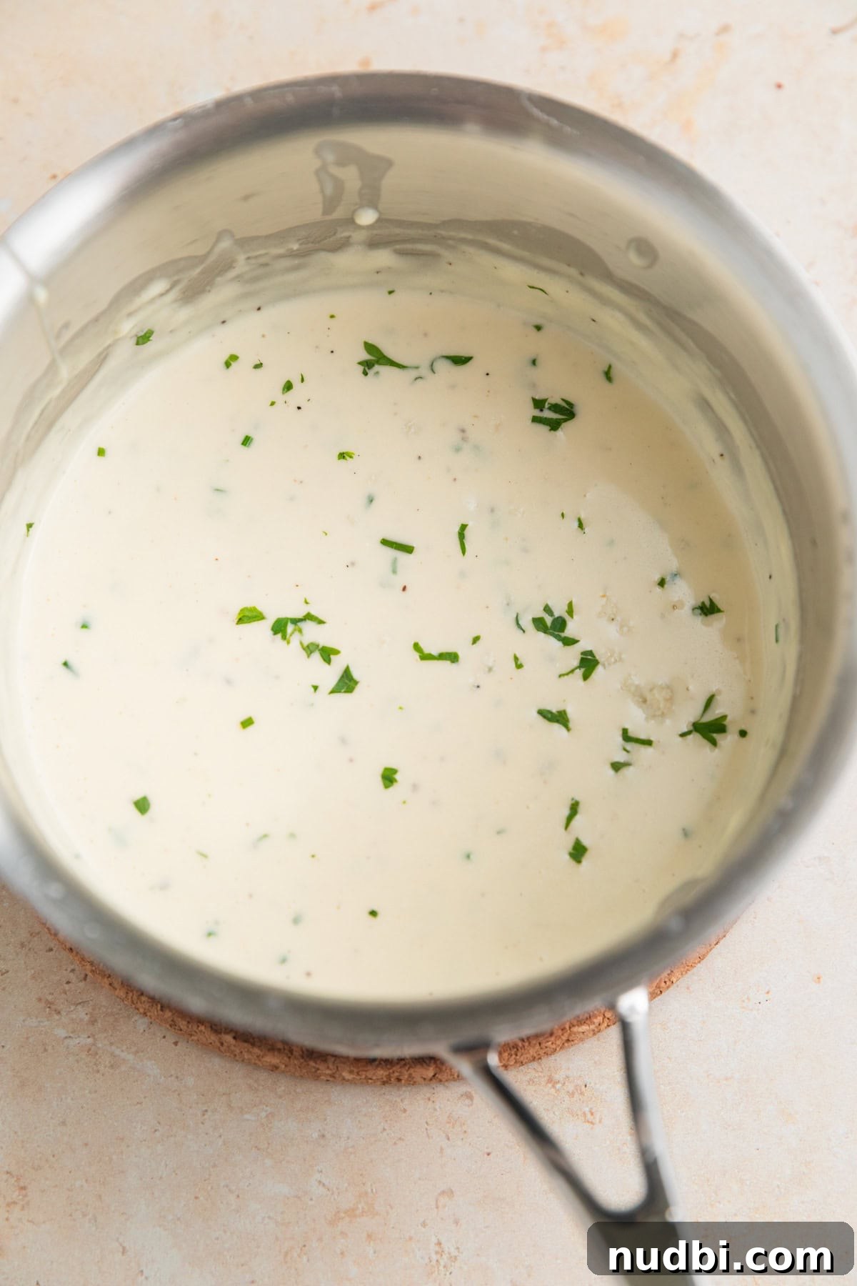 Grilled Ribeye with Creamy Gorgonzola Sauce Recipe 7 Gorgonzola sauce in pan topped with chopped parsley and chives.