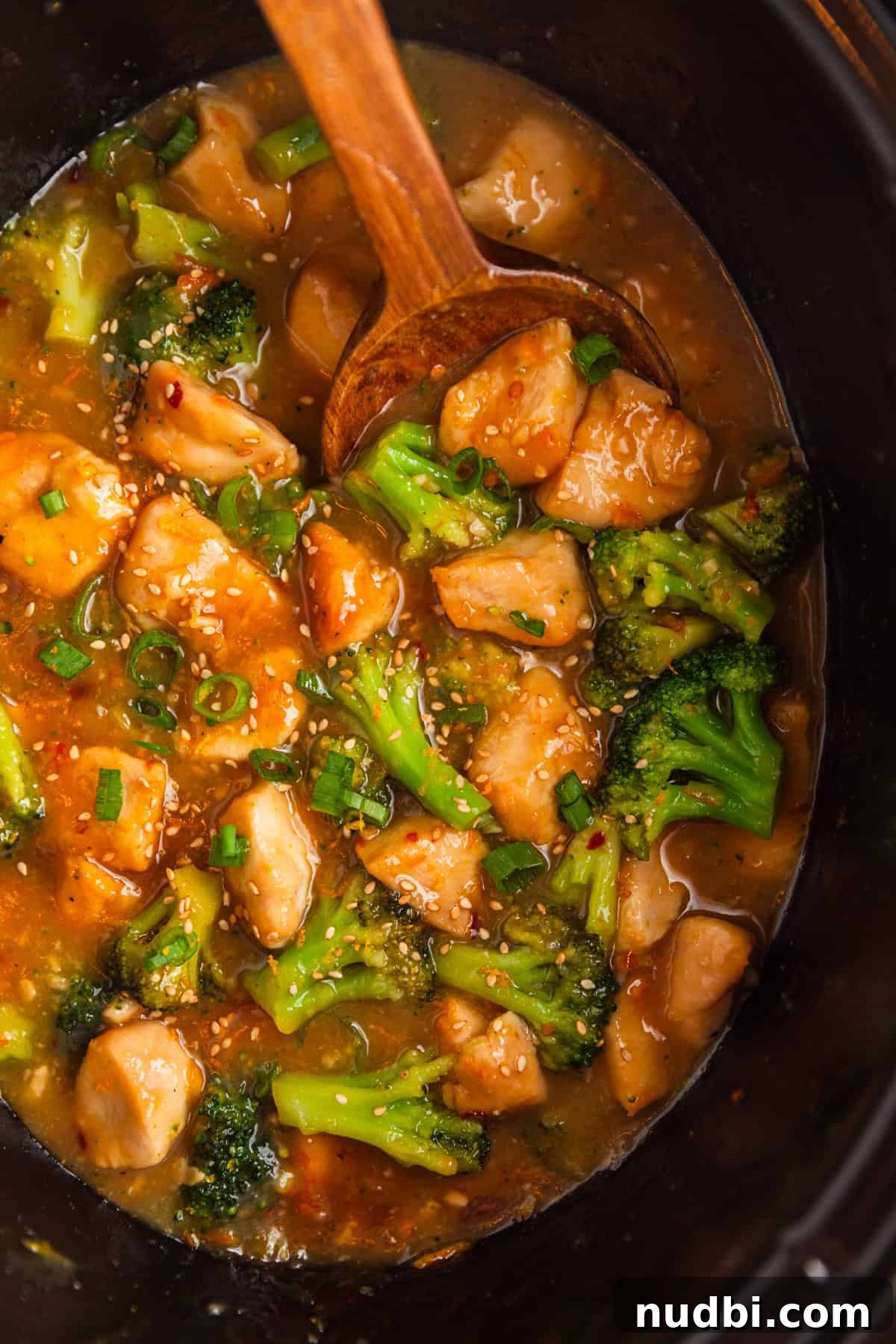 Slow-Cooker Orange Chicken Recipe for Tender, Saucy Chicken 12 Overhead view of crockpot with chicken and broccoli in orange sauce.