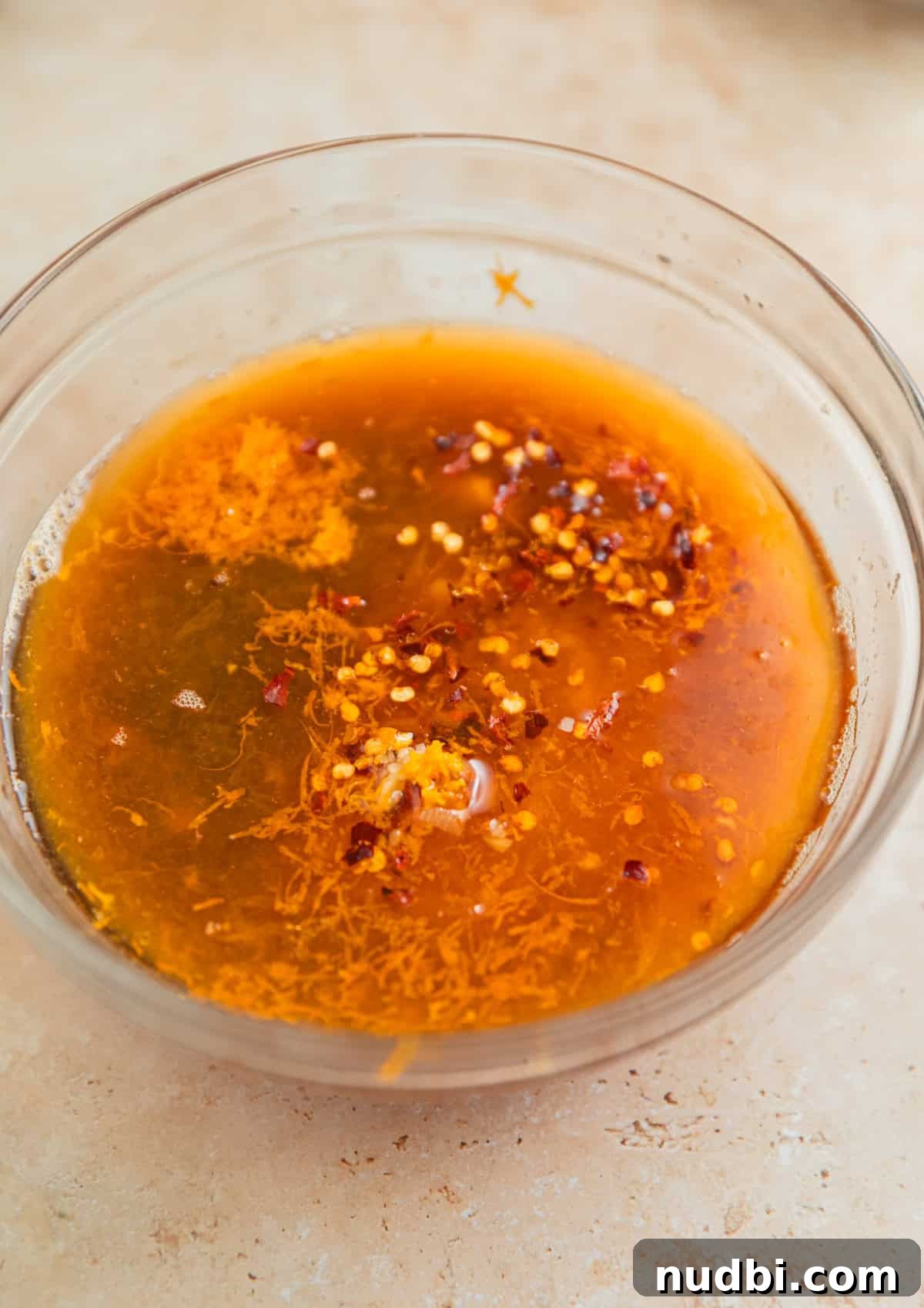 Slow-Cooker Orange Chicken Recipe for Tender, Saucy Chicken 4 Ingredients for orange chicken sauce in glass bowl.