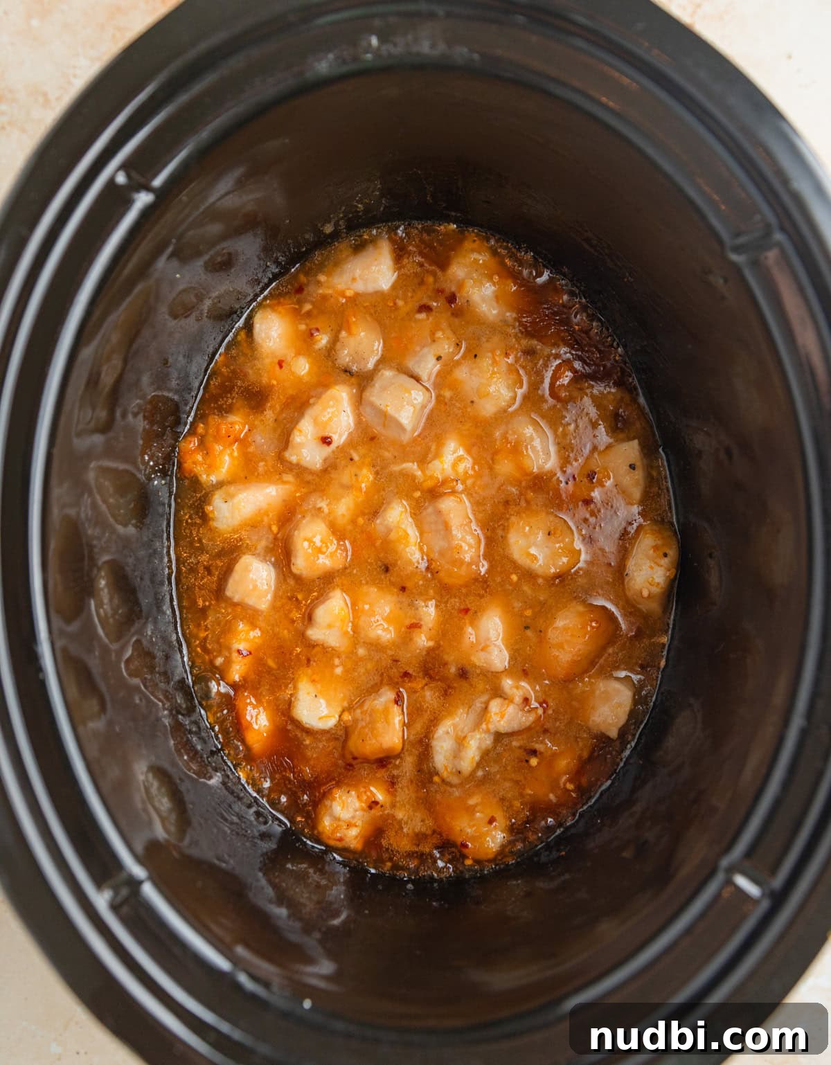 Slow-Cooker Orange Chicken Recipe for Tender, Saucy Chicken 9 Cooked orange chicken in crock pot.