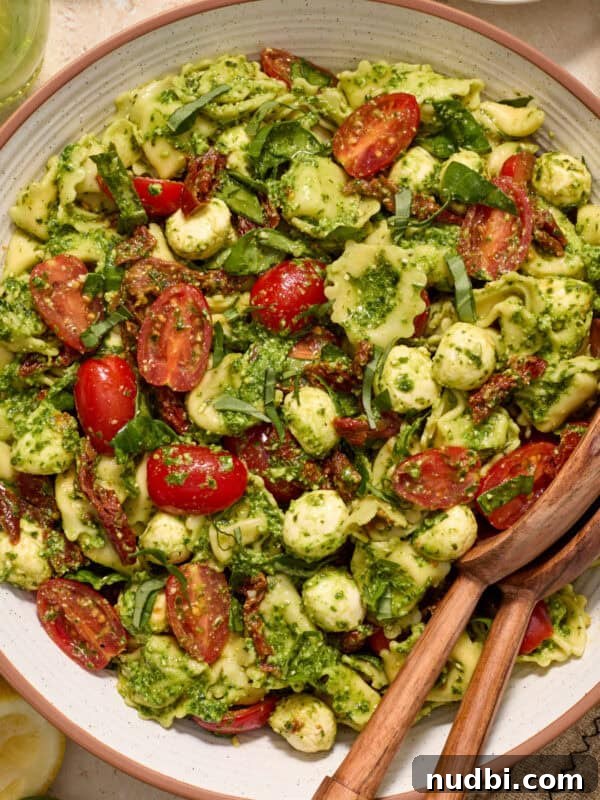Grilled Corn Chopped Salad with Lime and Cotija 14 Bowl with prepared pesto tortellini salad topped with fresh chopped basil.