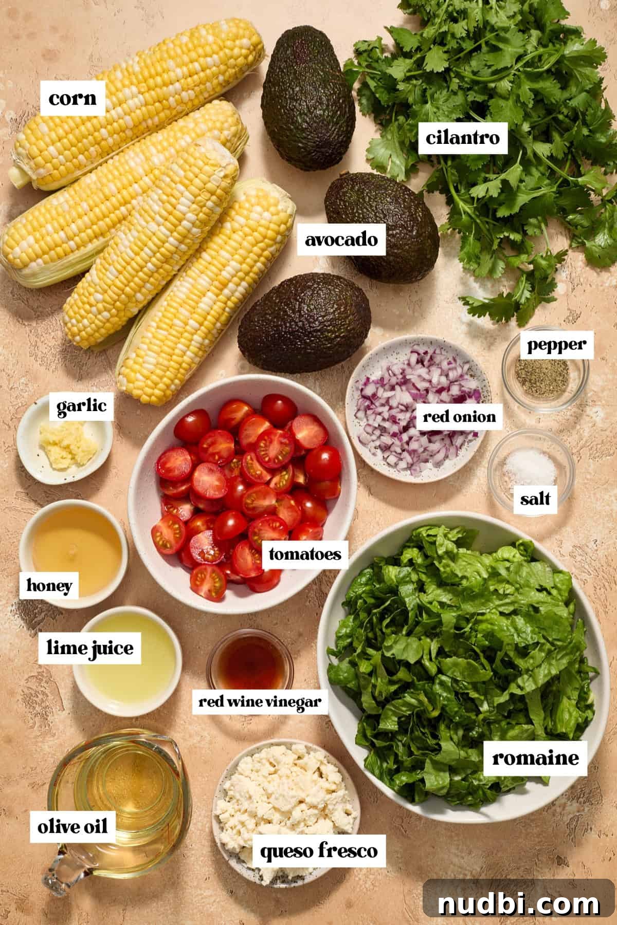 Grilled Corn Chopped Salad with Lime and Cotija 3 Cilantro, tomatoes, corn, romaine and other ingredients labeled on surface.