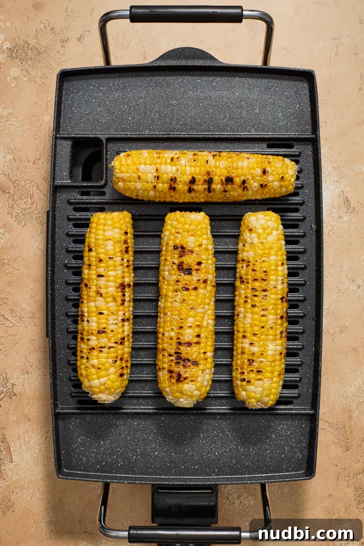 Grilled Corn Chopped Salad with Lime and Cotija 4 Corn being grilled on grill appliance.