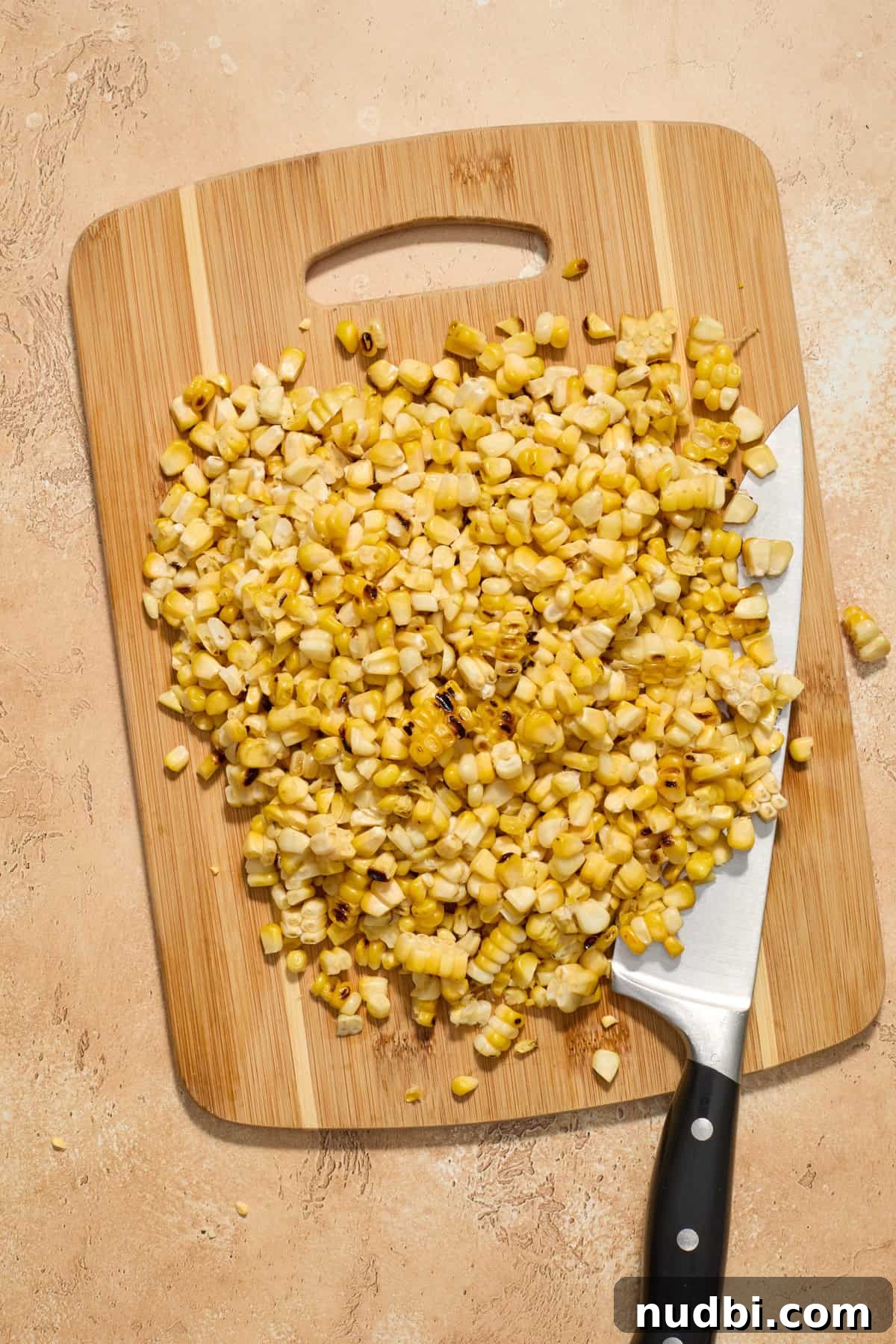 Grilled Corn Chopped Salad with Lime and Cotija 5 Grilled corn cut from the cob on cutting board.