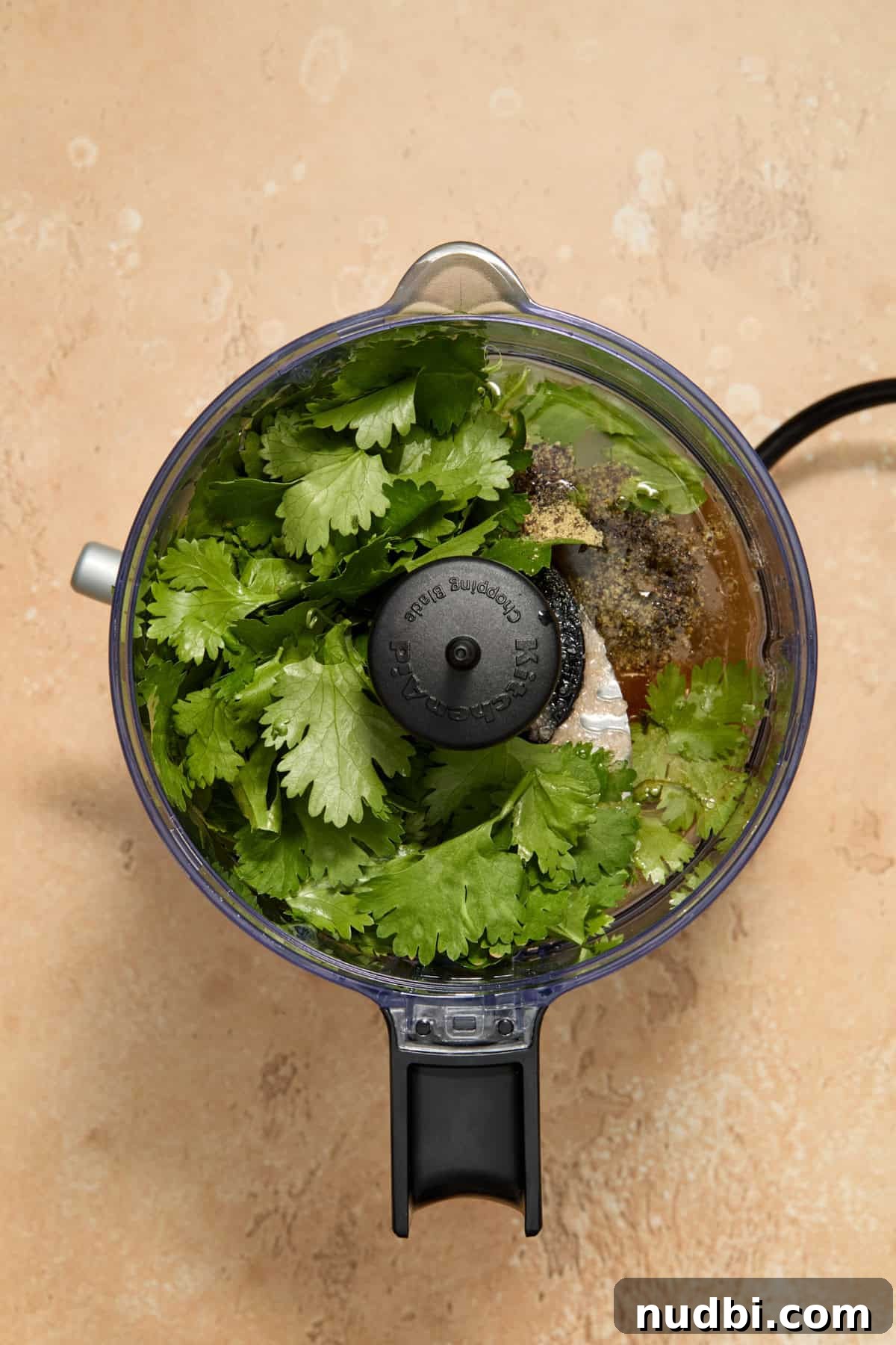 Grilled Corn Chopped Salad with Lime and Cotija 6 Food processor with cilantro lime ingredients for dressing before processed.