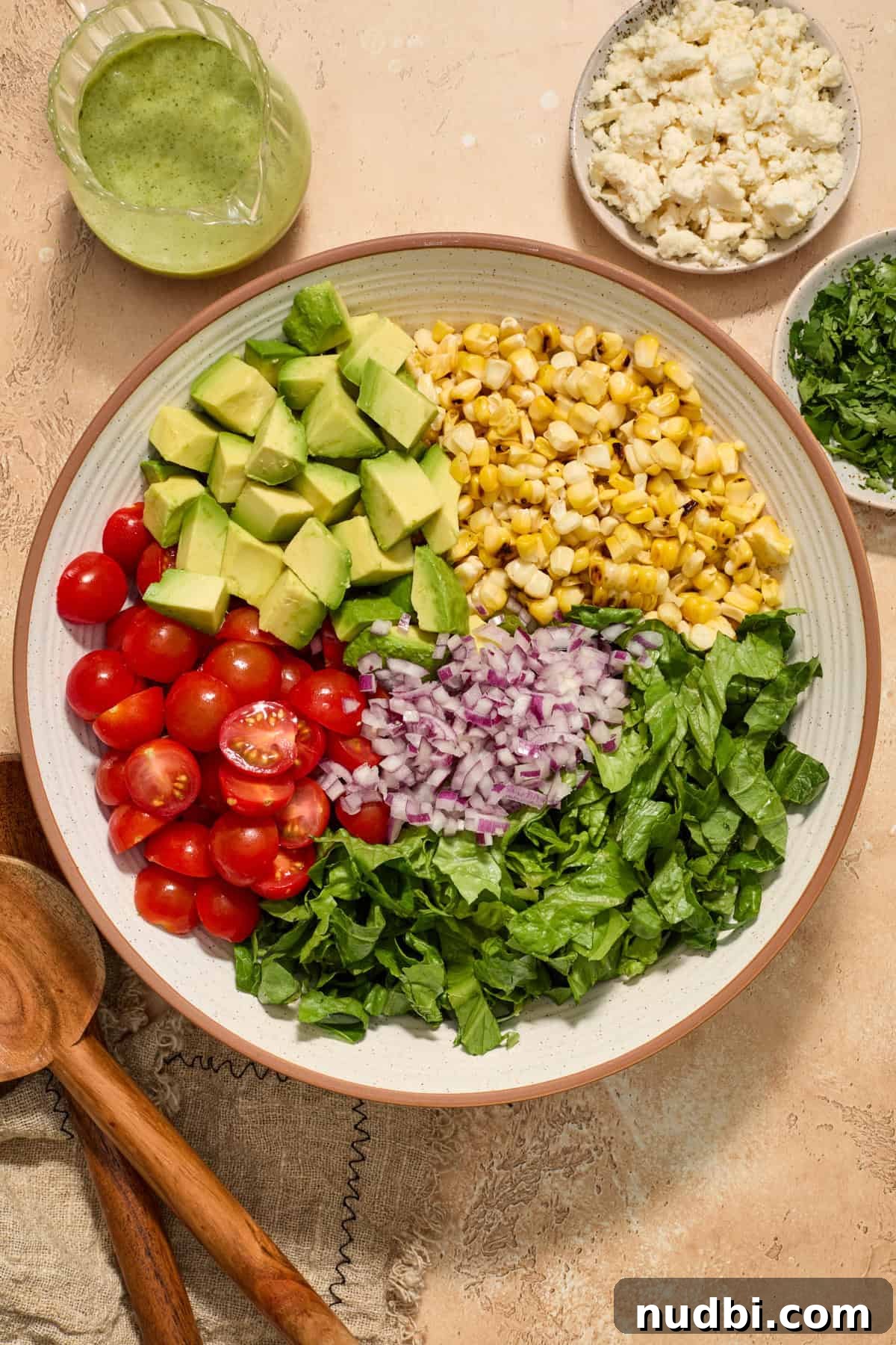 Grilled Corn Chopped Salad with Lime and Cotija 8 Grilled corn, chopped avocado, tomatoes and other ingredients arranged in salad bowl.