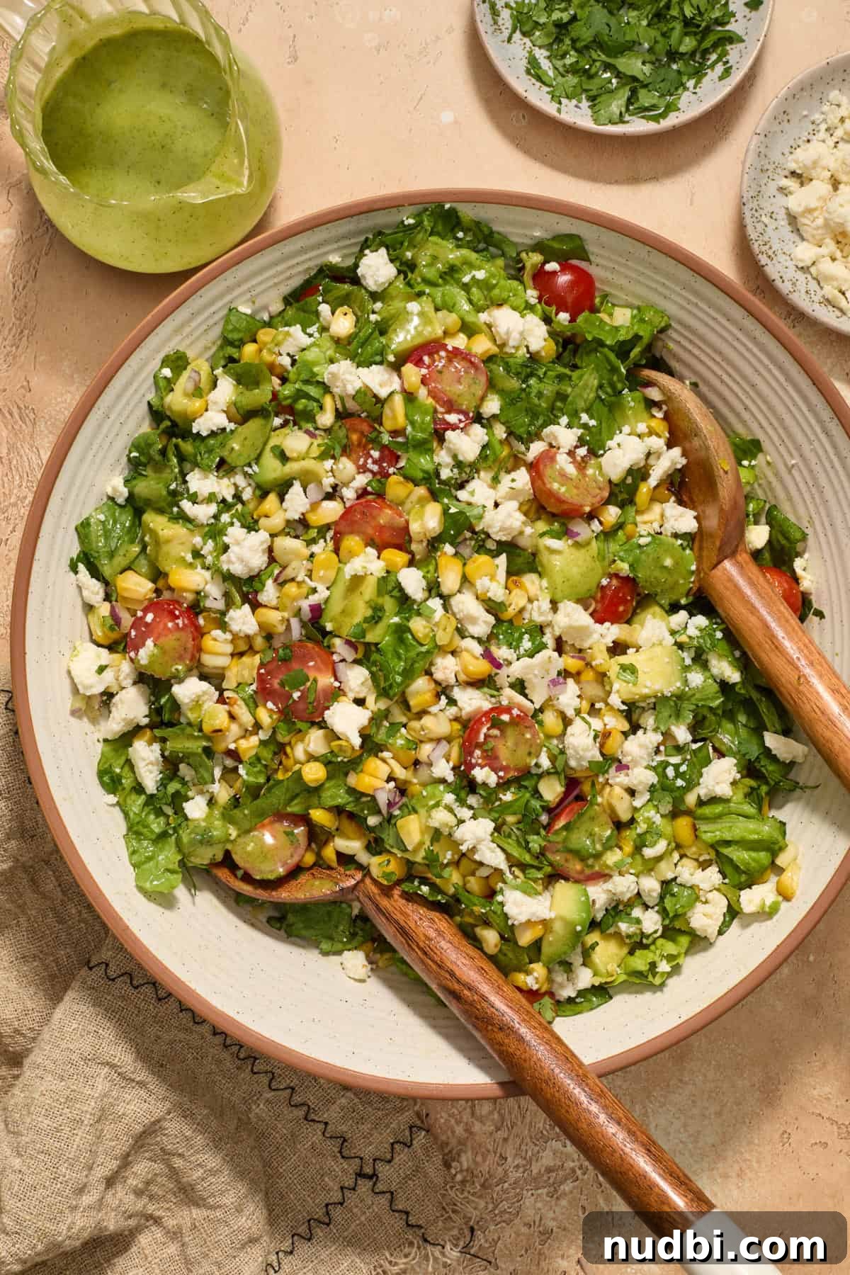 Grilled Corn Chopped Salad with Lime and Cotija 9 Tossed corn, tomato and avocado salad in bowl.