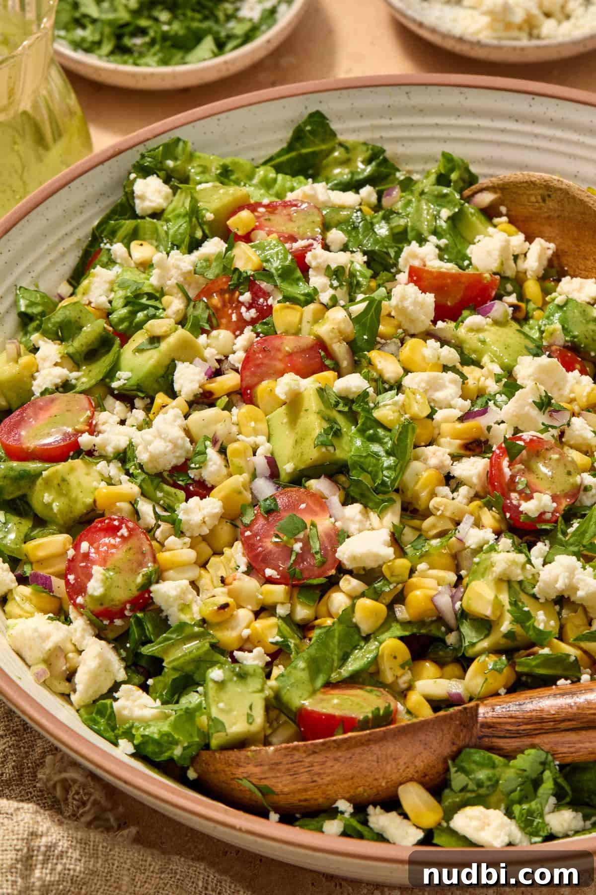Grilled Corn Chopped Salad with Lime and Cotija 10 Chopped salad with grilled corn, tomato and other ingredients in salad bowl.