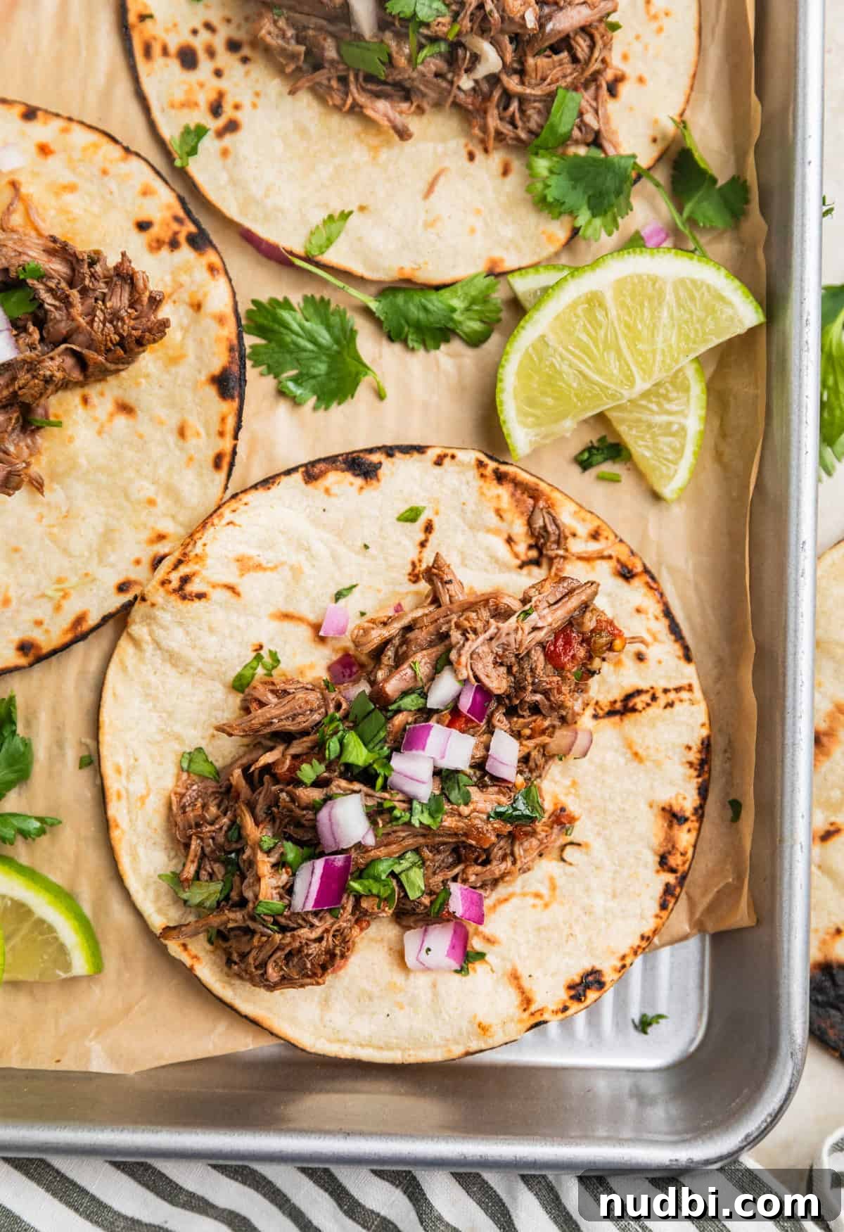 Slow-Cooker Shredded Beef Tacos Recipe for Tender, Flavorful Meat 11 Overhead view of beef tacos on tray.