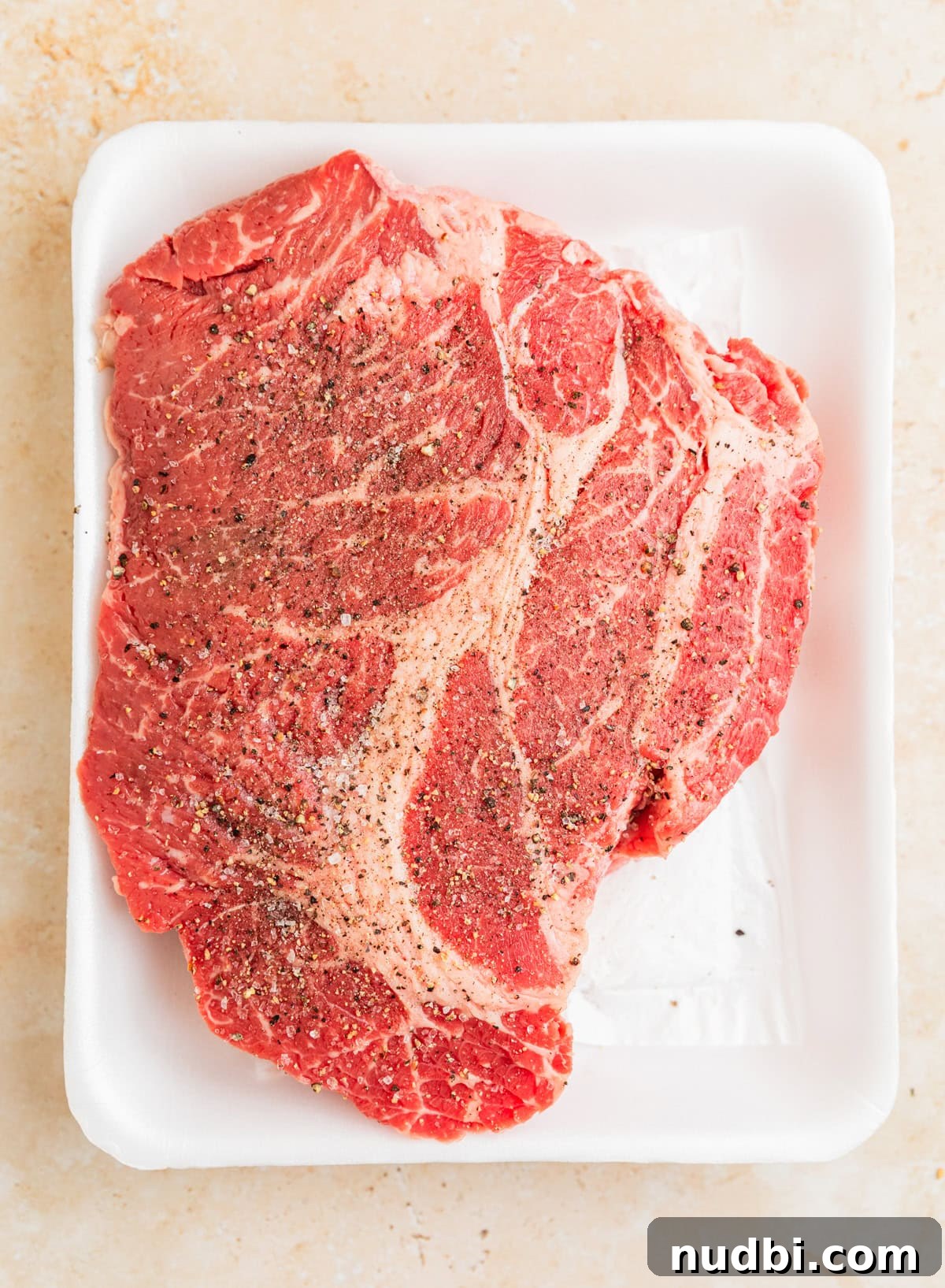 Slow-Cooker Shredded Beef Tacos Recipe for Tender, Flavorful Meat 4 Piece of raw chuck roast seasoned before searing.