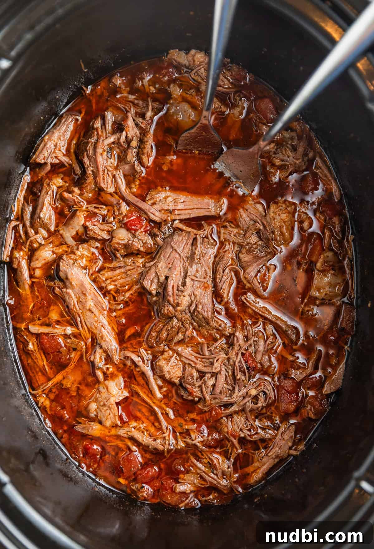 Slow-Cooker Shredded Beef Tacos Recipe for Tender, Flavorful Meat 8 Shredded beef tacos in crock pot with forks.
