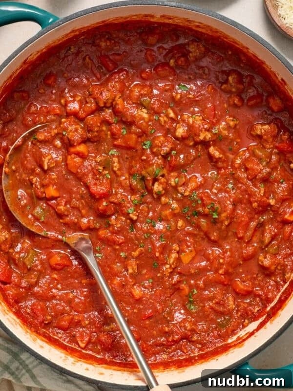 Savory Ground Turkey Rice Bowls with Veggies and Soy-Ginger Sauce 11 Ground turkey spaghetti sauce in pot with ladle.