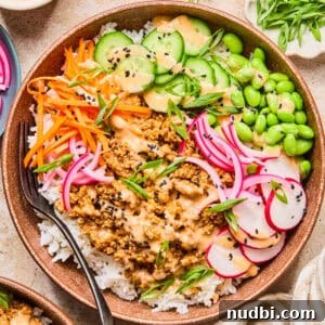 Savory Ground Turkey Rice Bowls with Veggies and Soy-Ginger Sauce 13 Rice bowl with ground turkey, bang bang sauce, cucumber, carrots and other ingredients.