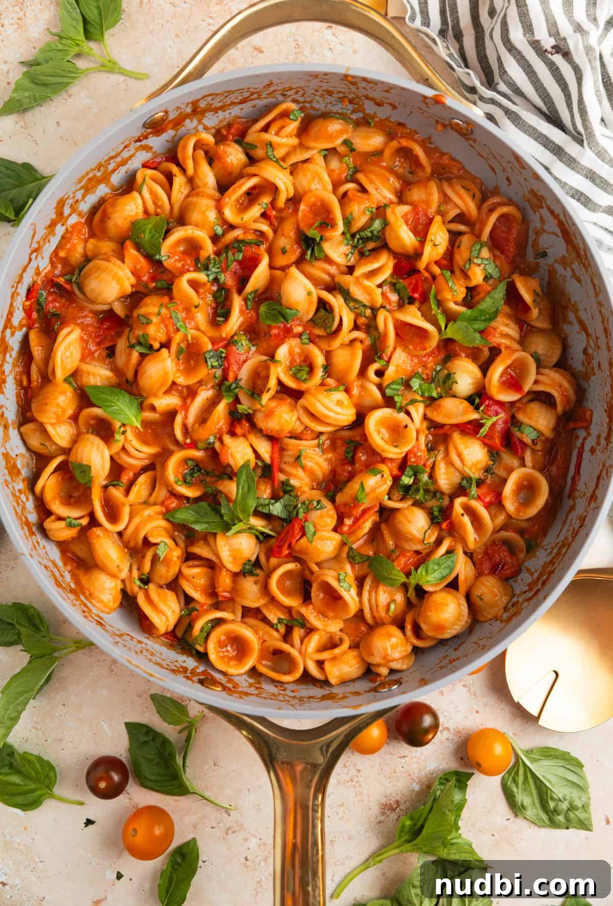 Quick Cherry Tomato Pasta Recipe for Fresh Weeknight Dinners 11 Fresh cherry tomato pasta in pan topped with fresh basil.
