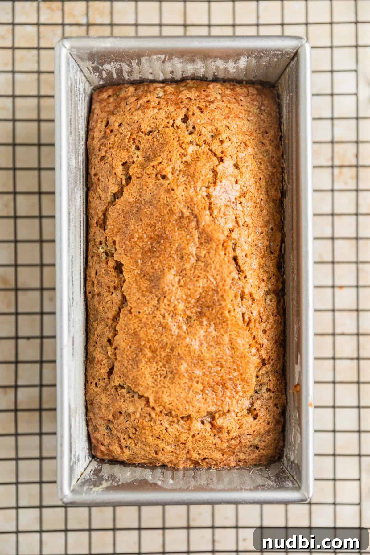 Grandma’s Zucchini Bread Recipe (Even Better) 13 Baked zucchini bread in pan on cooling rack.